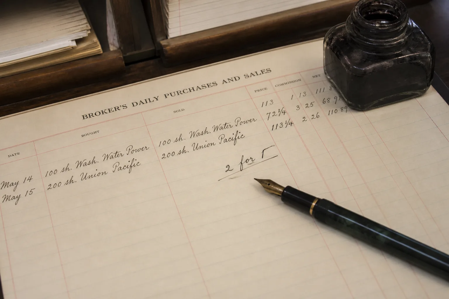 Broker blotter with a handwritten two-for-one note